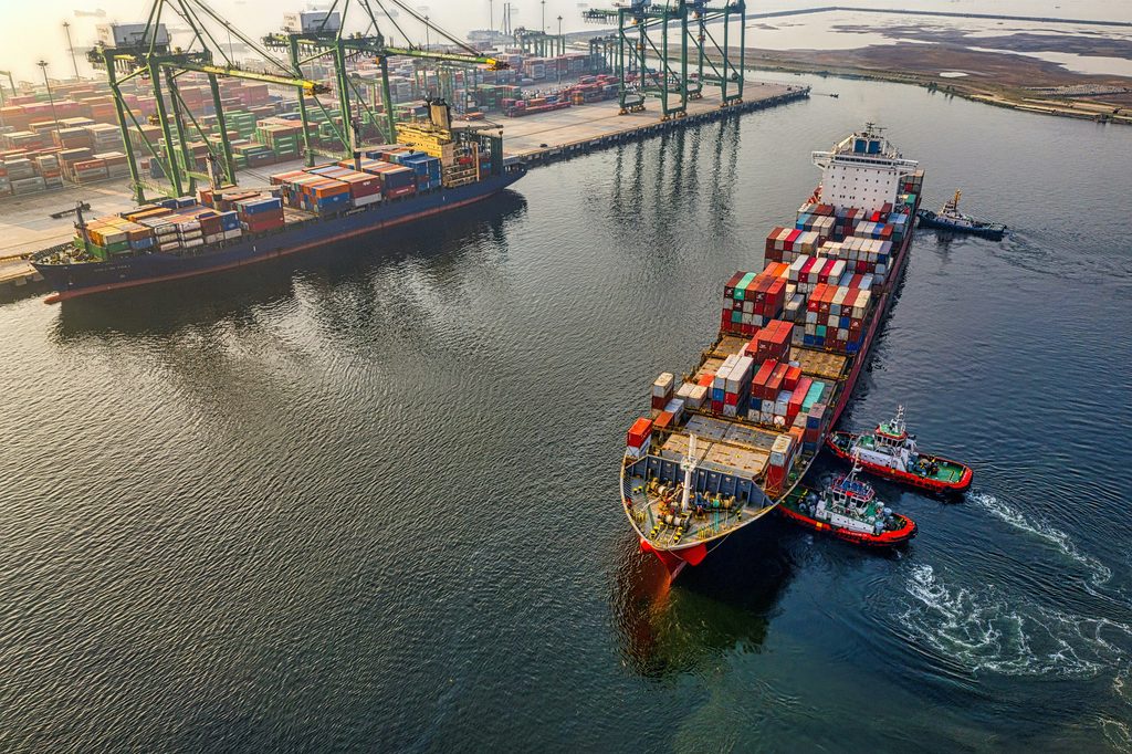 Container ship leaving a commodity port
